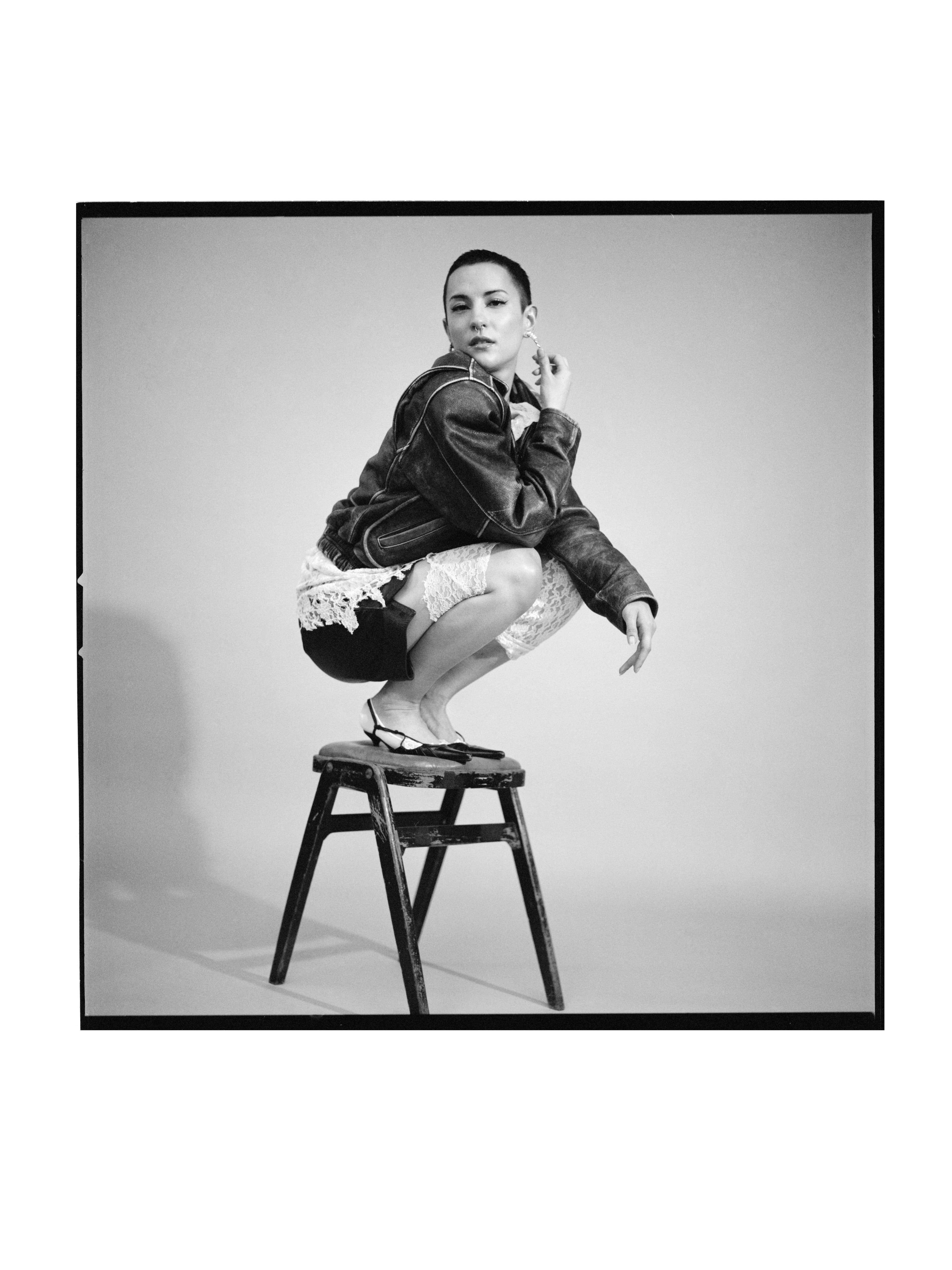 Vintage jacket by Hein Gericke. Vintage shirt, worn on legs, by Sisley. Vintage shorts. Vintage shoes by Diesel.