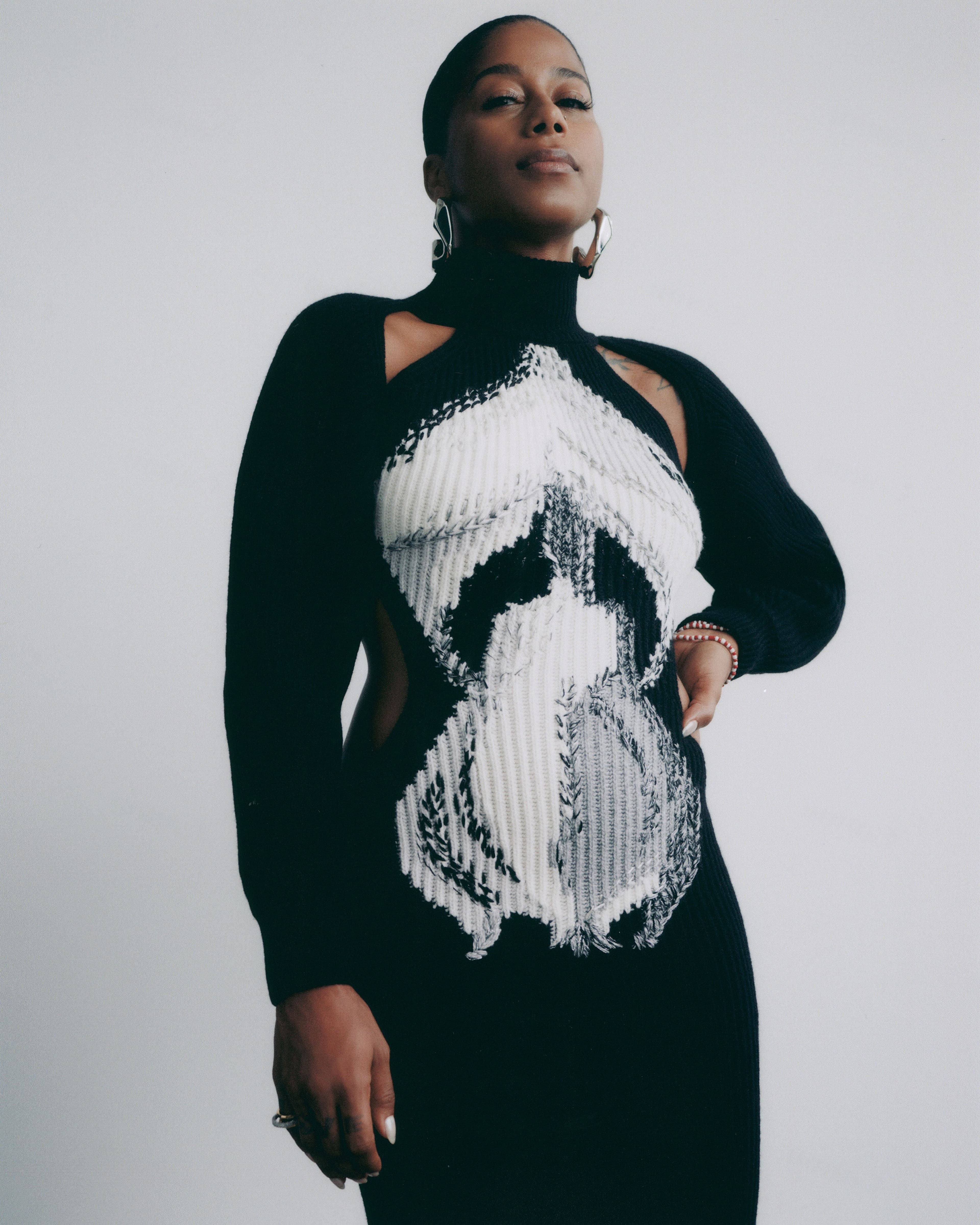 Dress and earrings by Alexander McQueen. Rings by Alexis Bittar.