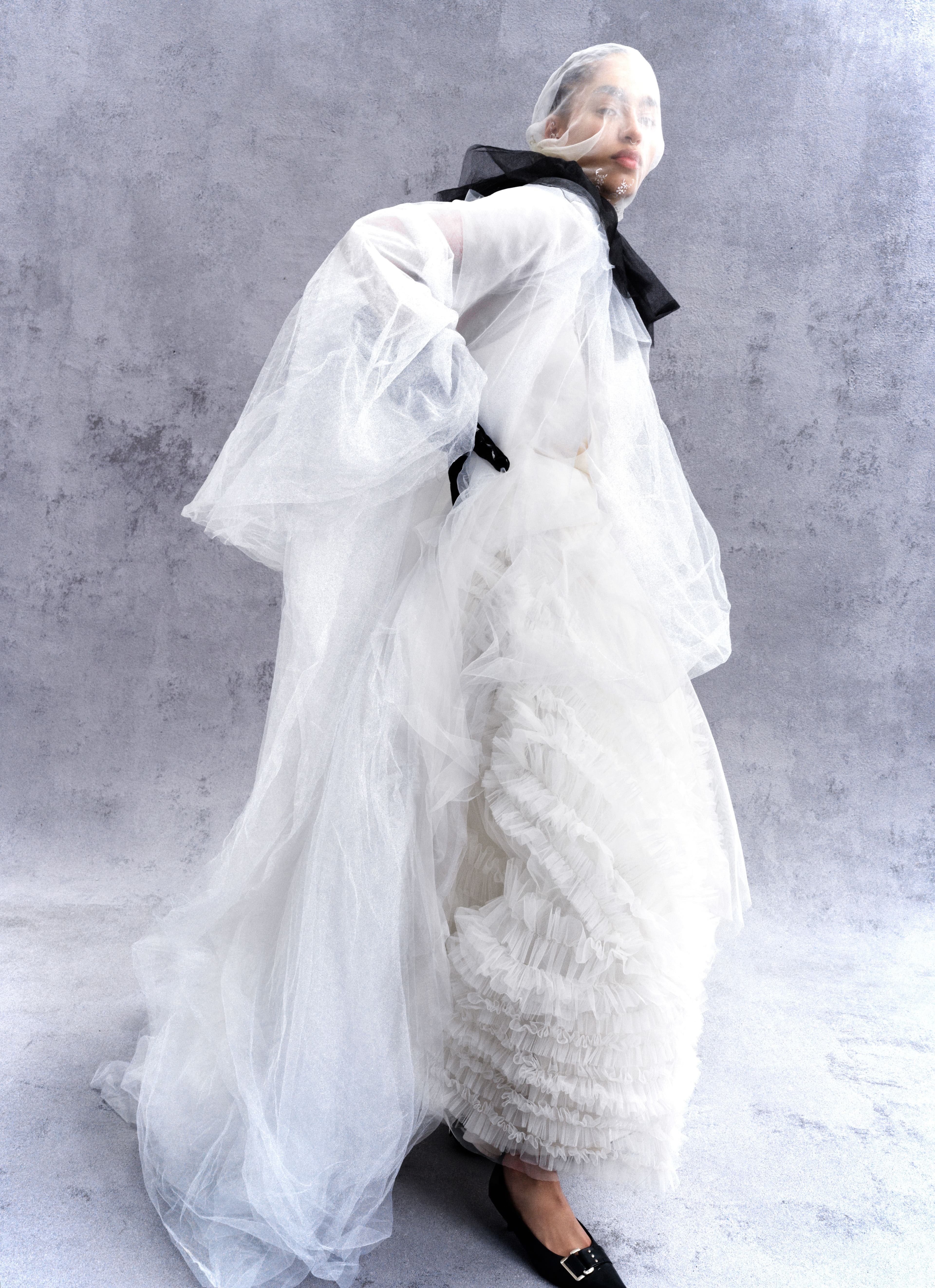 Dress, headpiece, neckpiece, and shoes, stylist’s own. Skirt, worn underneath, by Molly Goddard. Gloves by Versace.