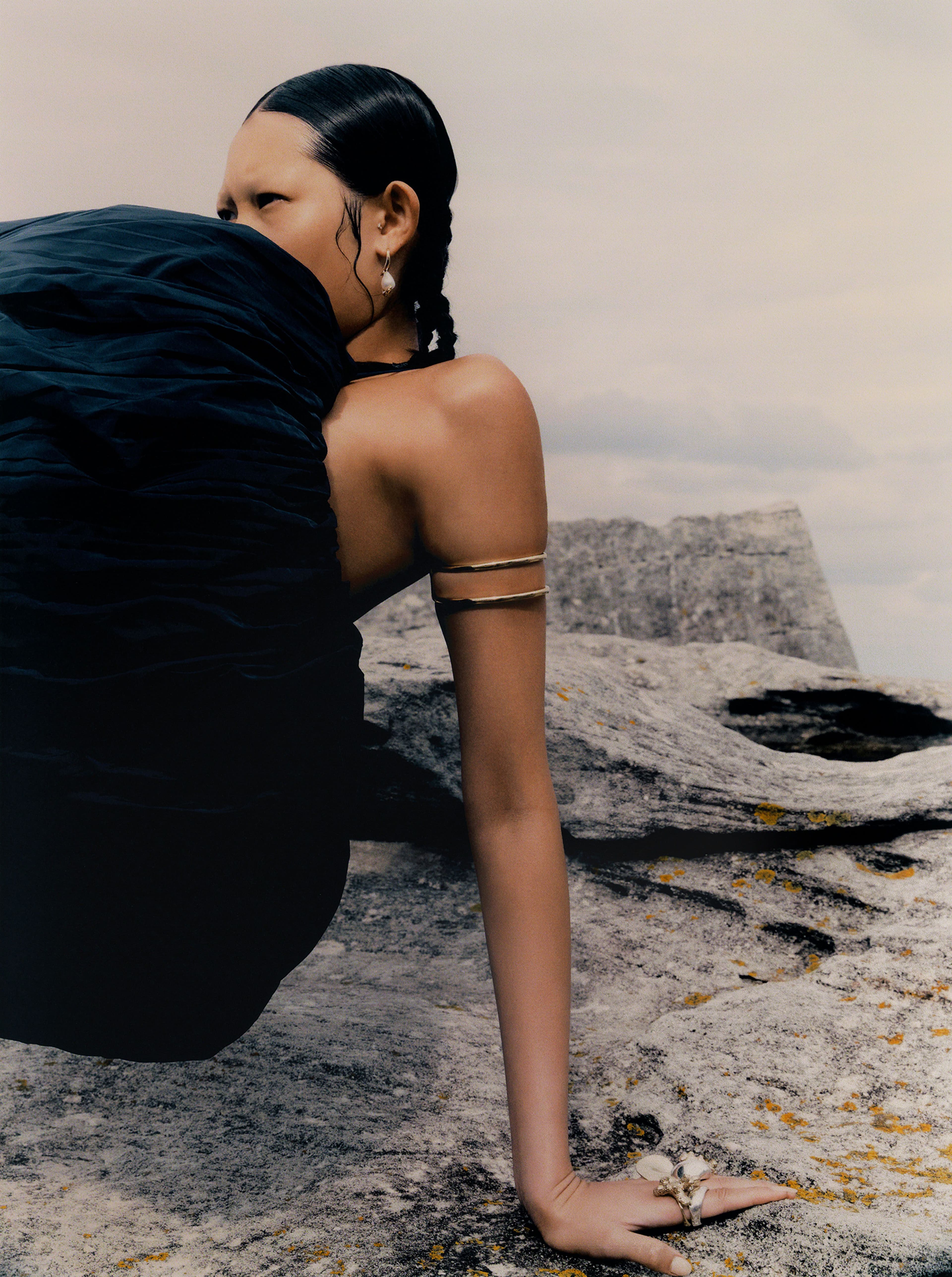 Top by Jordan Dalah. Earrings by Jordan Askill. Arm cuff by Christopher Esber. All rigns by Dinosaur Designs.