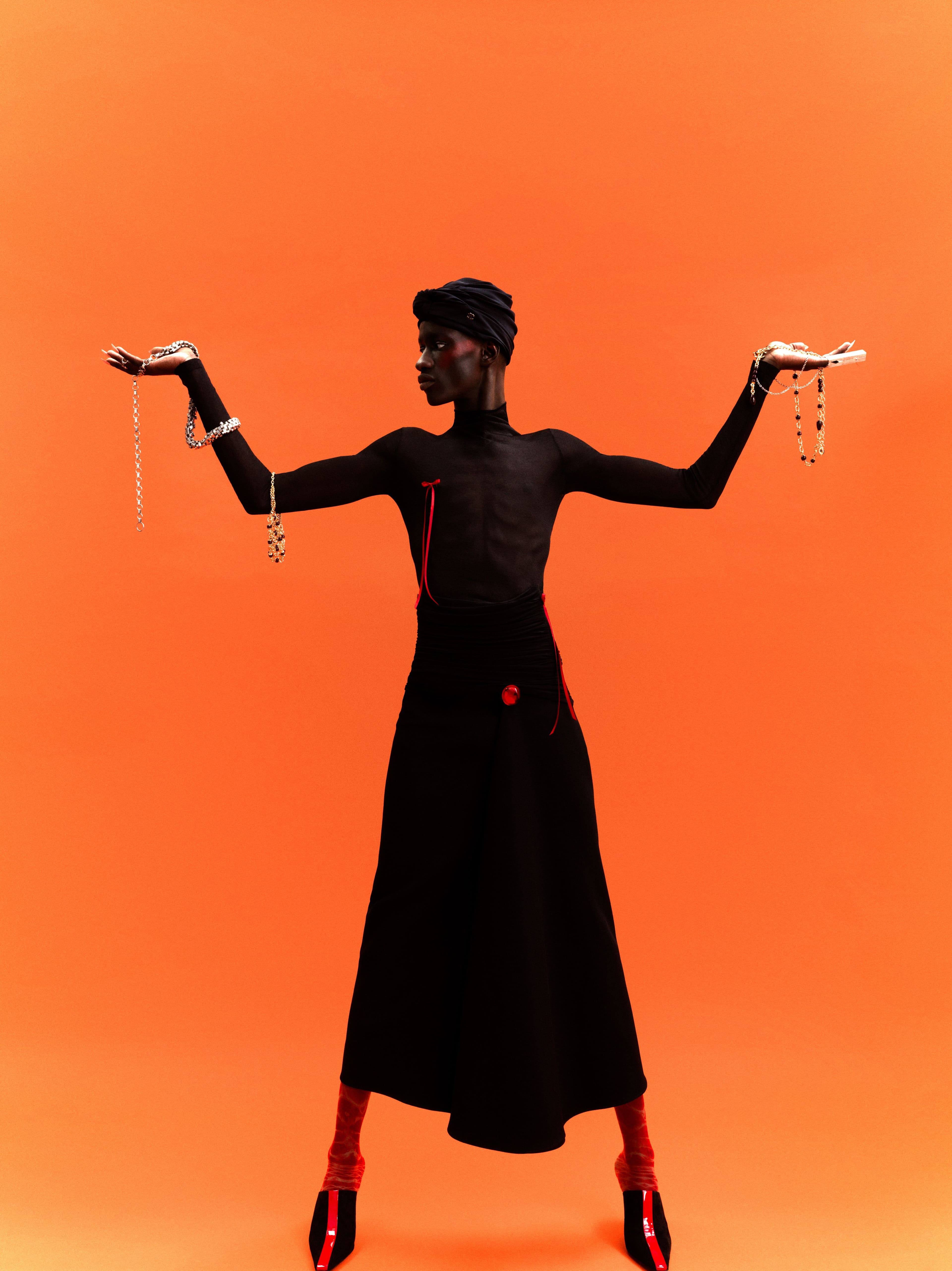 All clothing and shoes by Ferragamo. Headpiece and jewelry, held in hands, by Chanel. Earrings, worn as brooches, by Simone Rocha. Tights, stylist’s own.