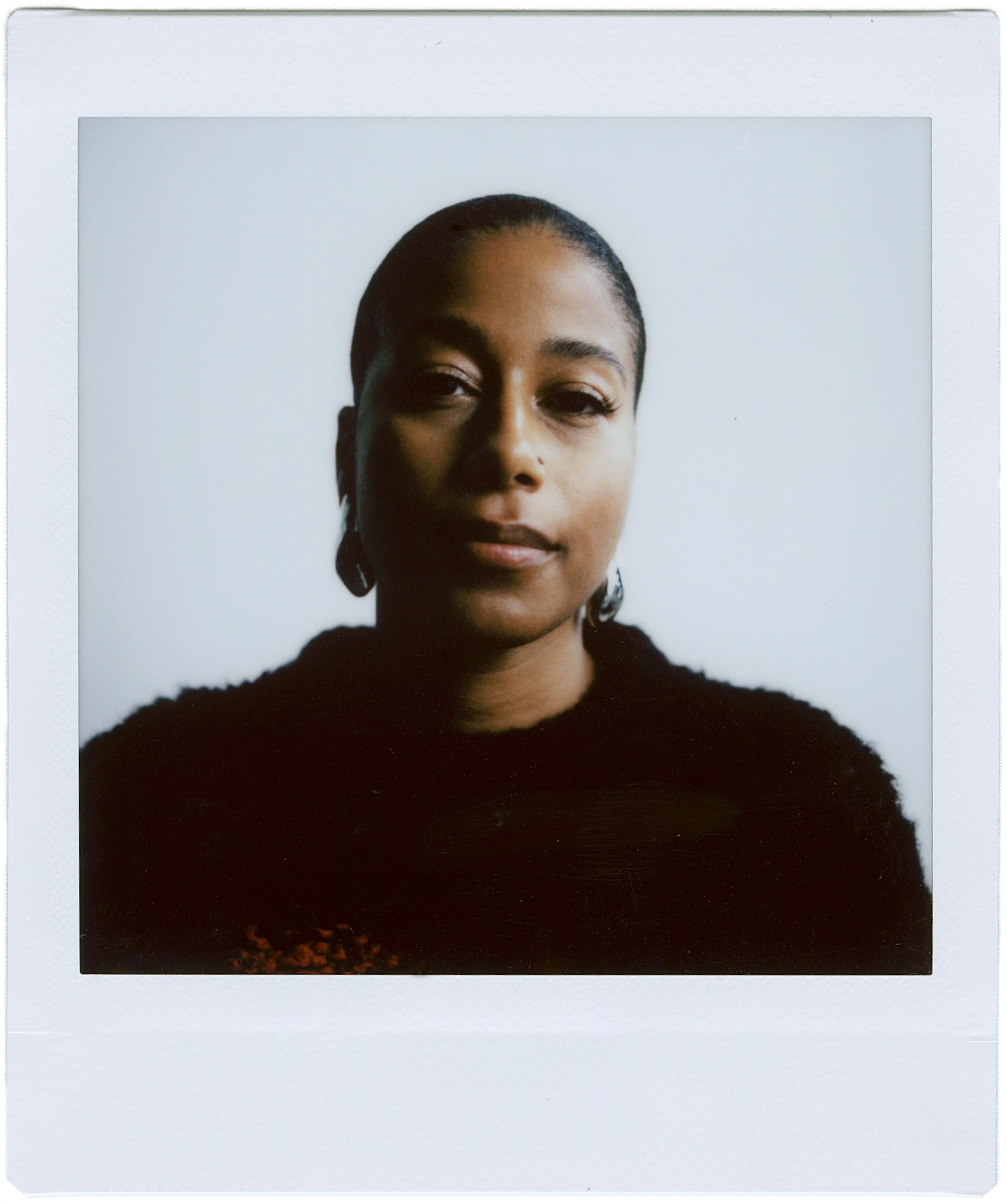 Sweater by Stella McCartney. Earrings by Alexis Bittar.