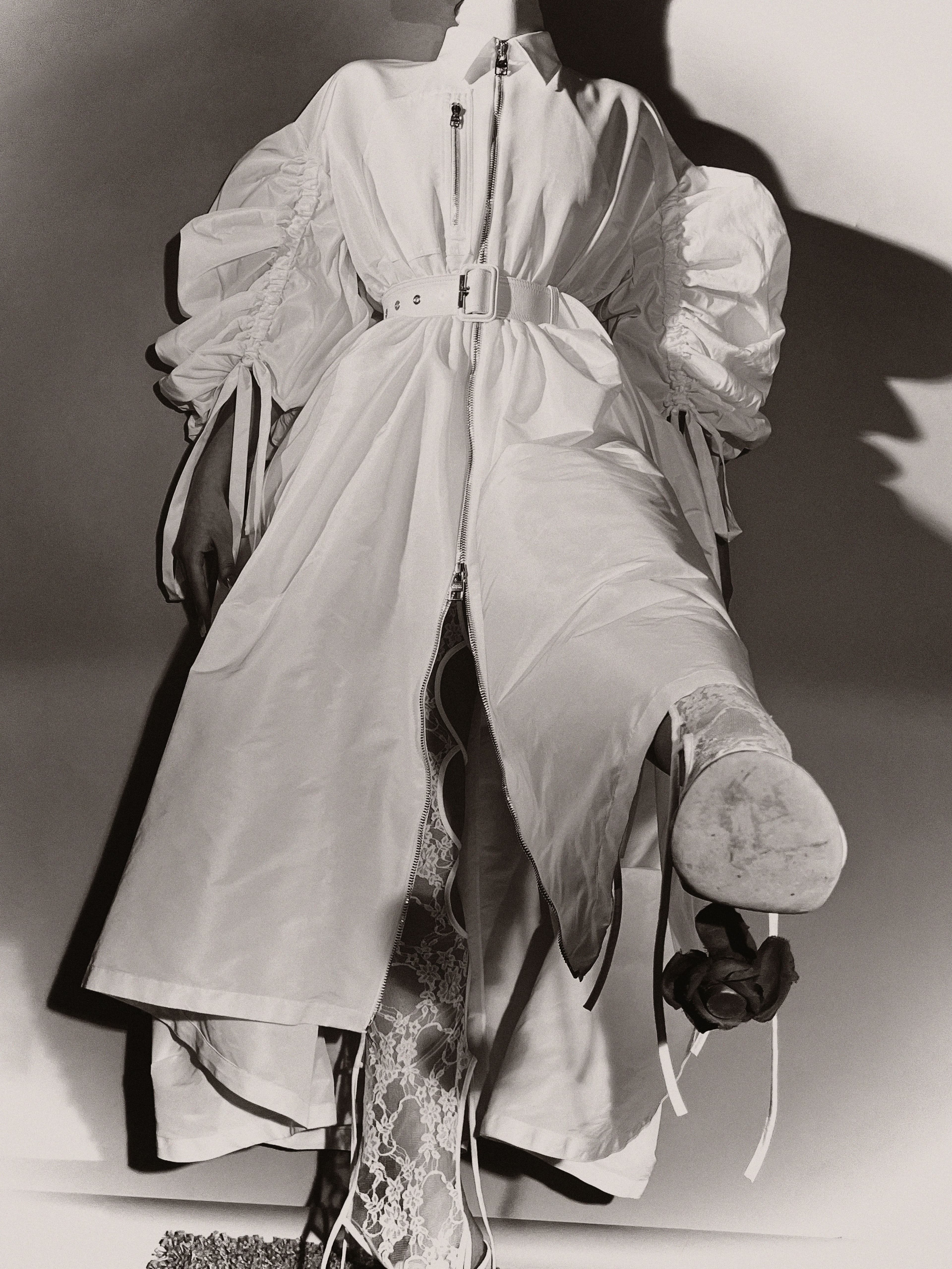 Dress by Alexander McQueen. Bodysuit by Nicolas Guichard. Shoes by Loewe.