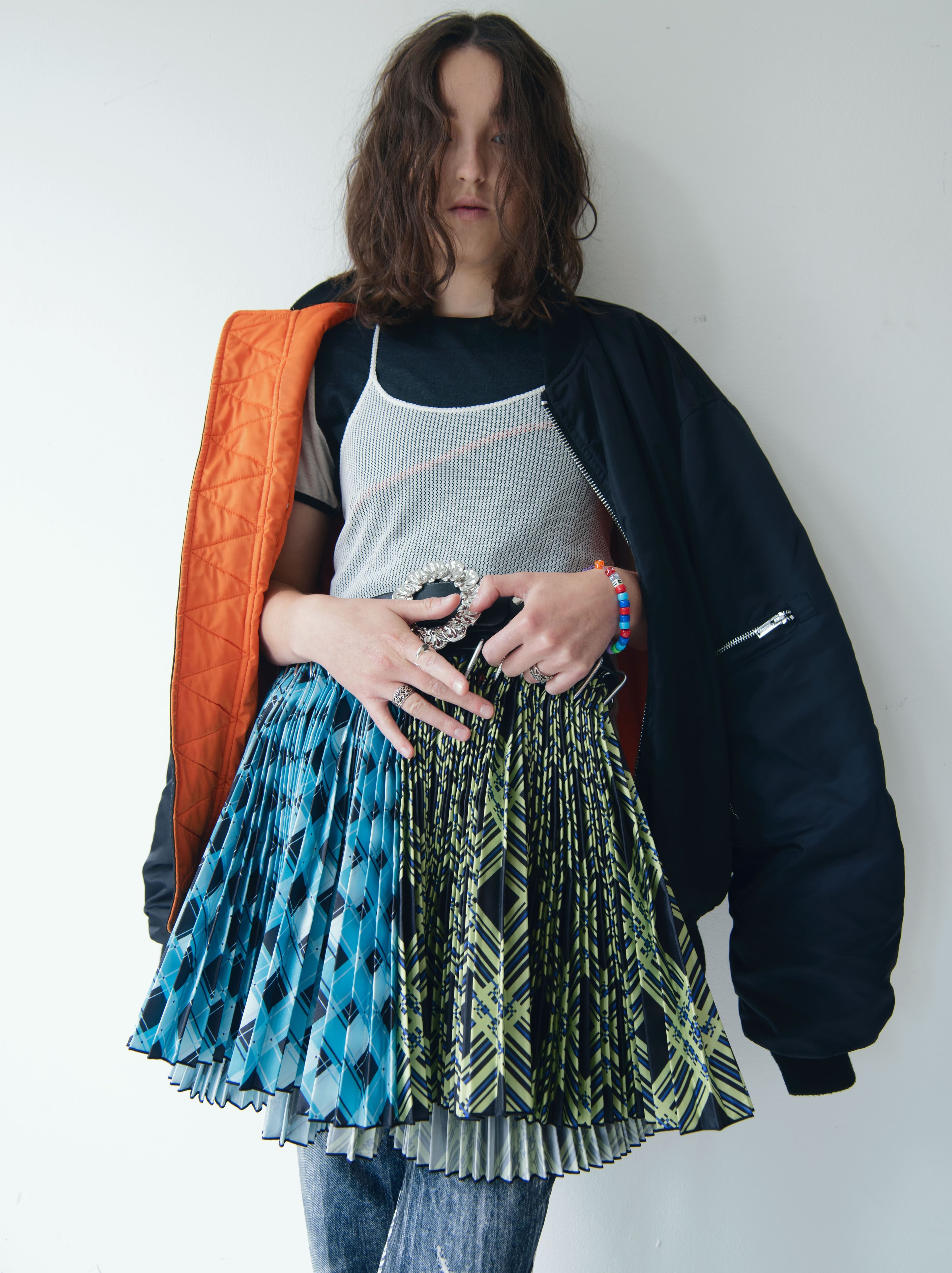 Jacket by Holzweiler. Tank top by Our Legacy. Vintage t-shirt and pants, stylist’s own. Skirt by Chopova Lowena. All jewelry throughout, Ramsey’s own.