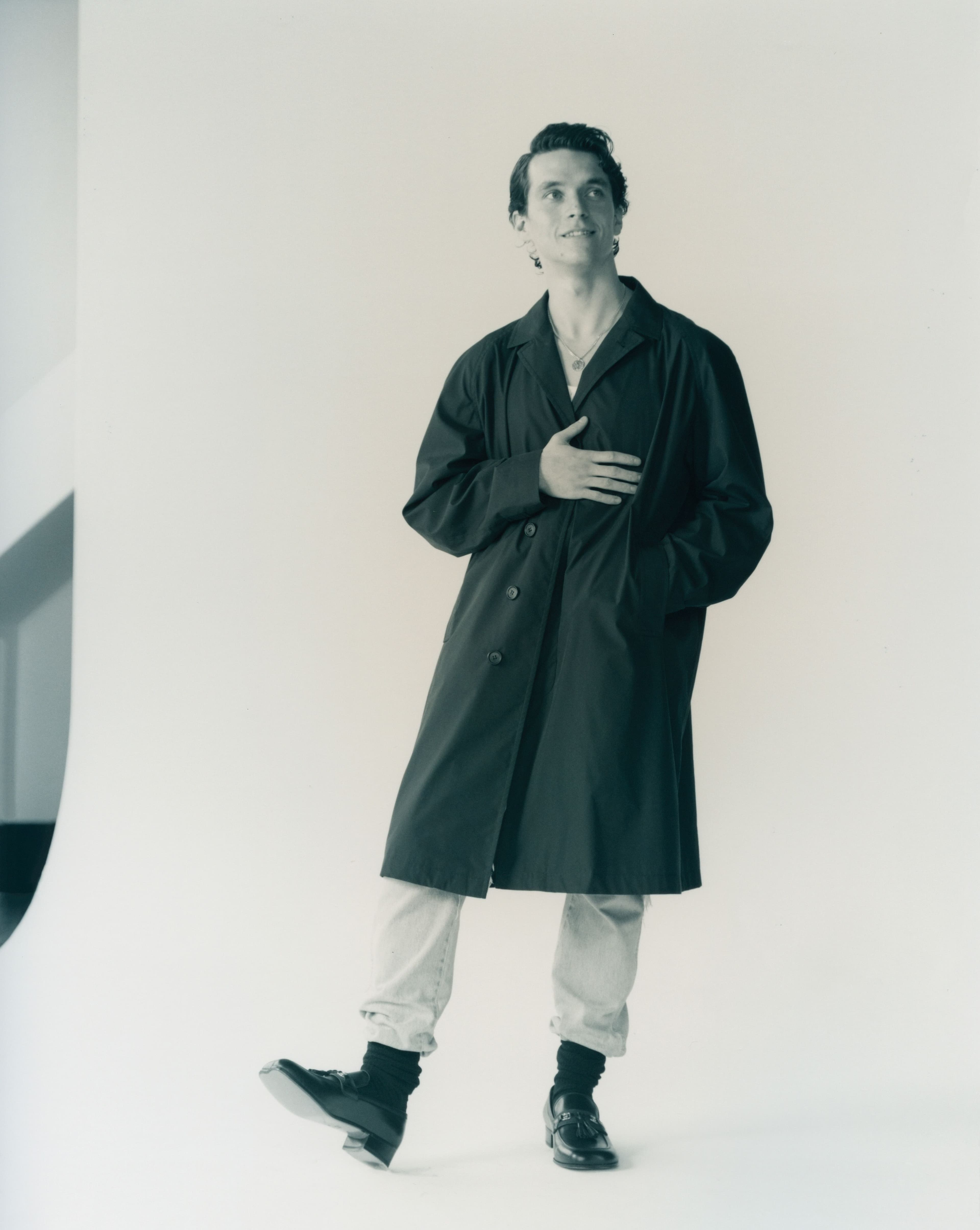 Coat by Prada. Top and jeans, stylist’s own. Shoes by Gucci. Socks by Falke.