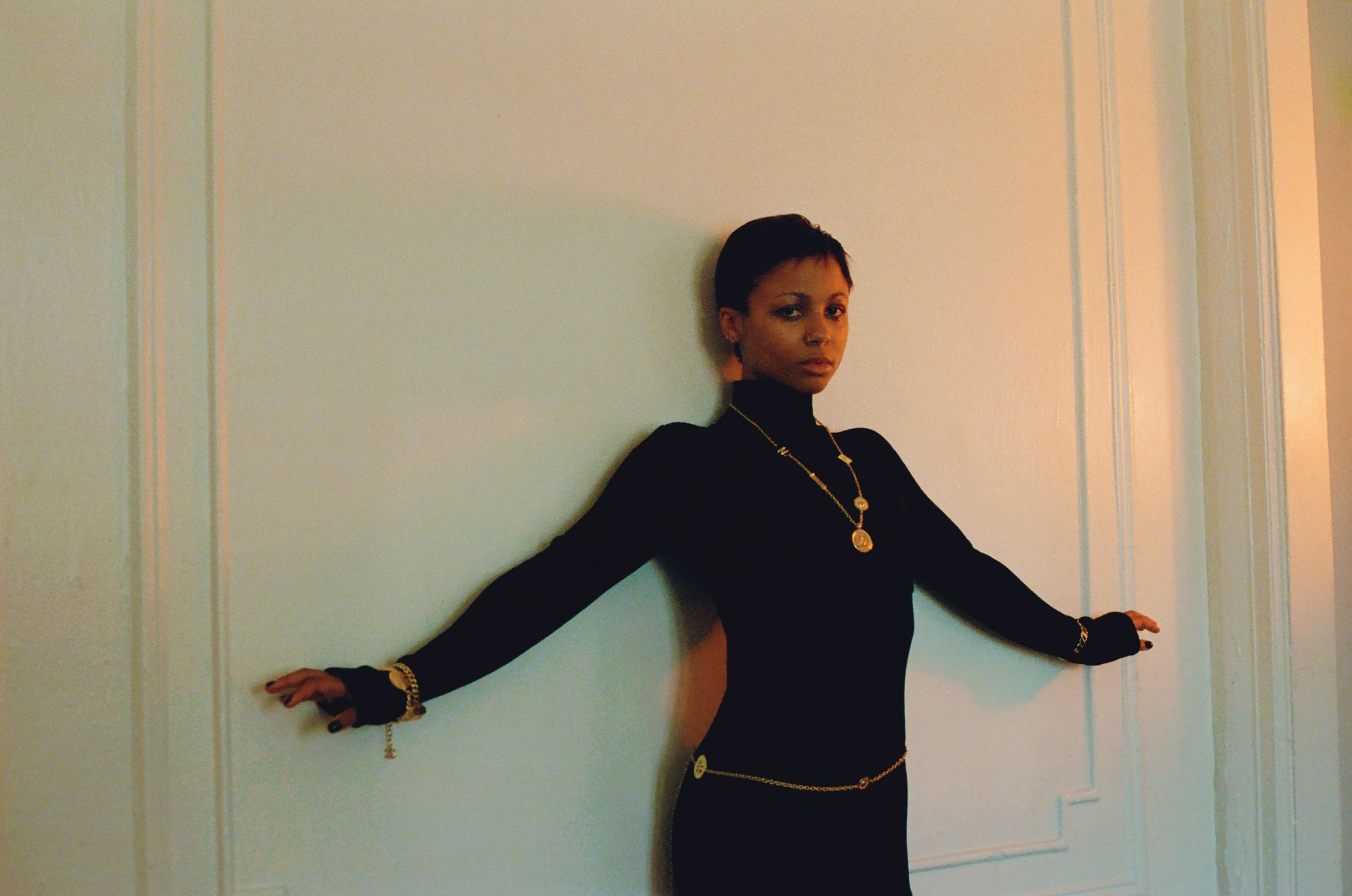 DRESS and CHAINS by ,Chanel. ,EARRINGS and RING, Myha’la’s own.