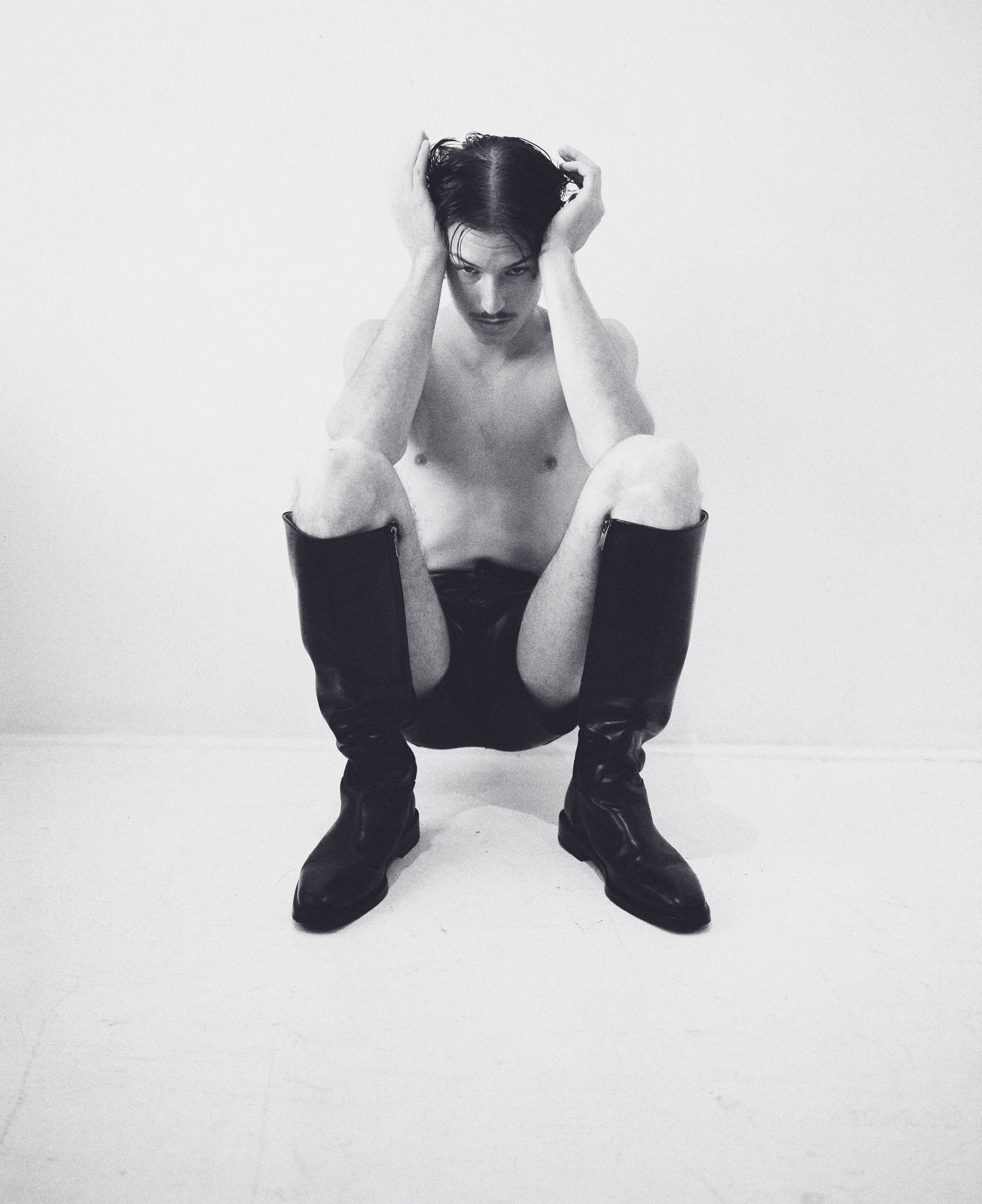 Shorts and boots by Ferragamo. Earrings by Spinelli Kilcollin.